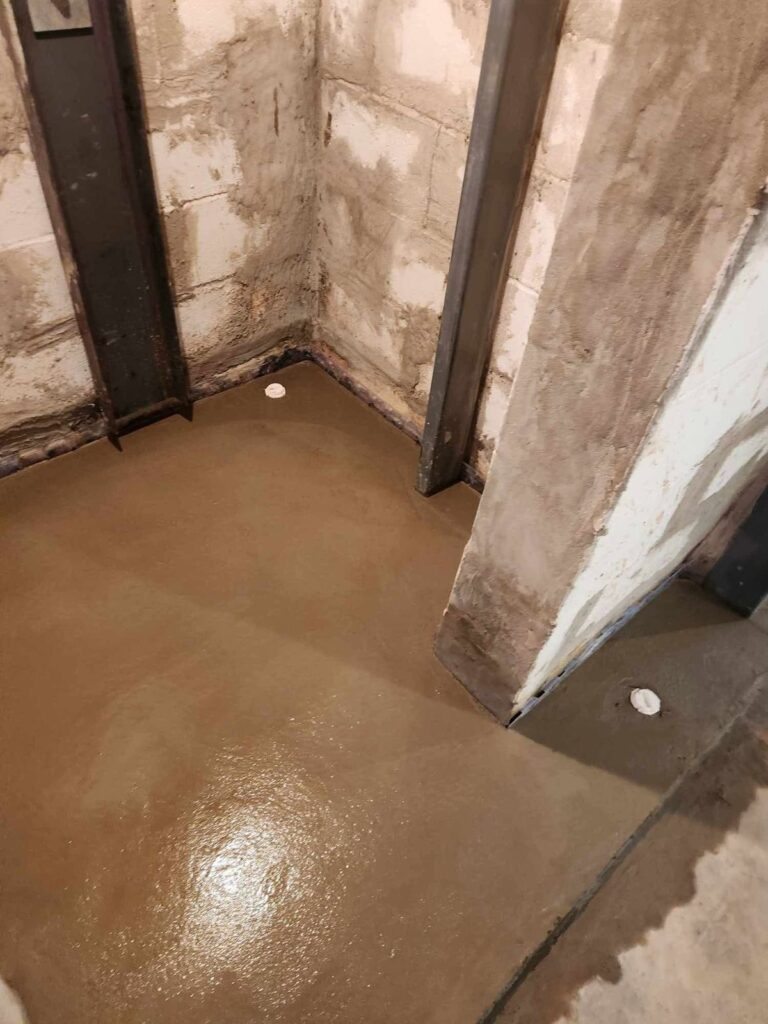 Interior basement waterproofing and foundation repair project in Menasha, WI (photo 1)