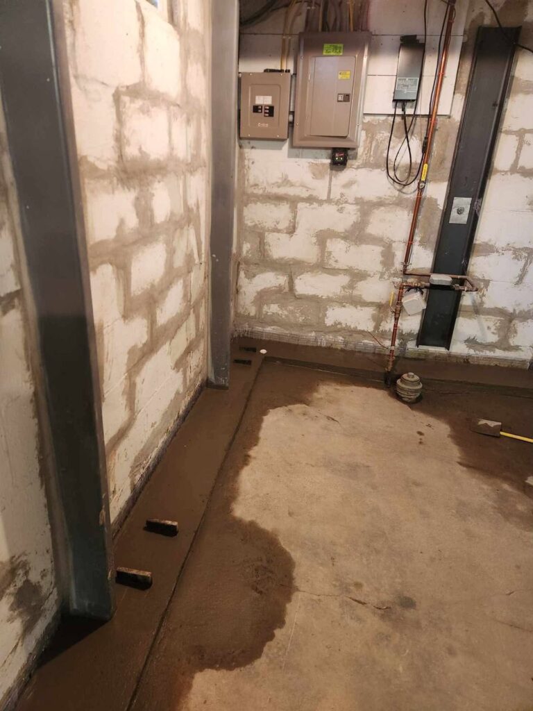 Interior basement waterproofing and foundation repair project in Menasha, WI (photo 11)
