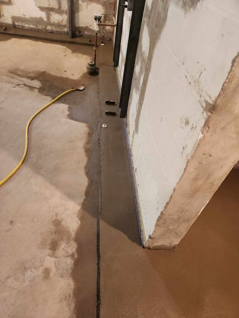 Interior basement waterproofing and foundation repair project in Menasha, WI (photo 13)