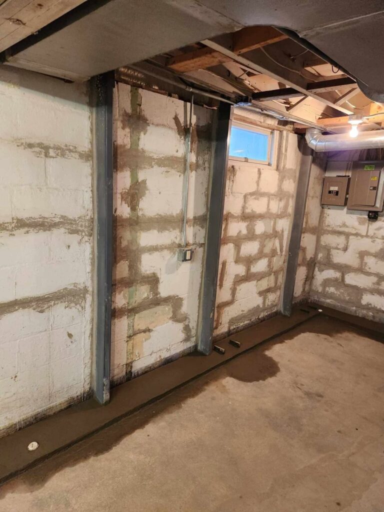 Interior basement waterproofing and foundation repair project in Menasha, WI (photo 6)
