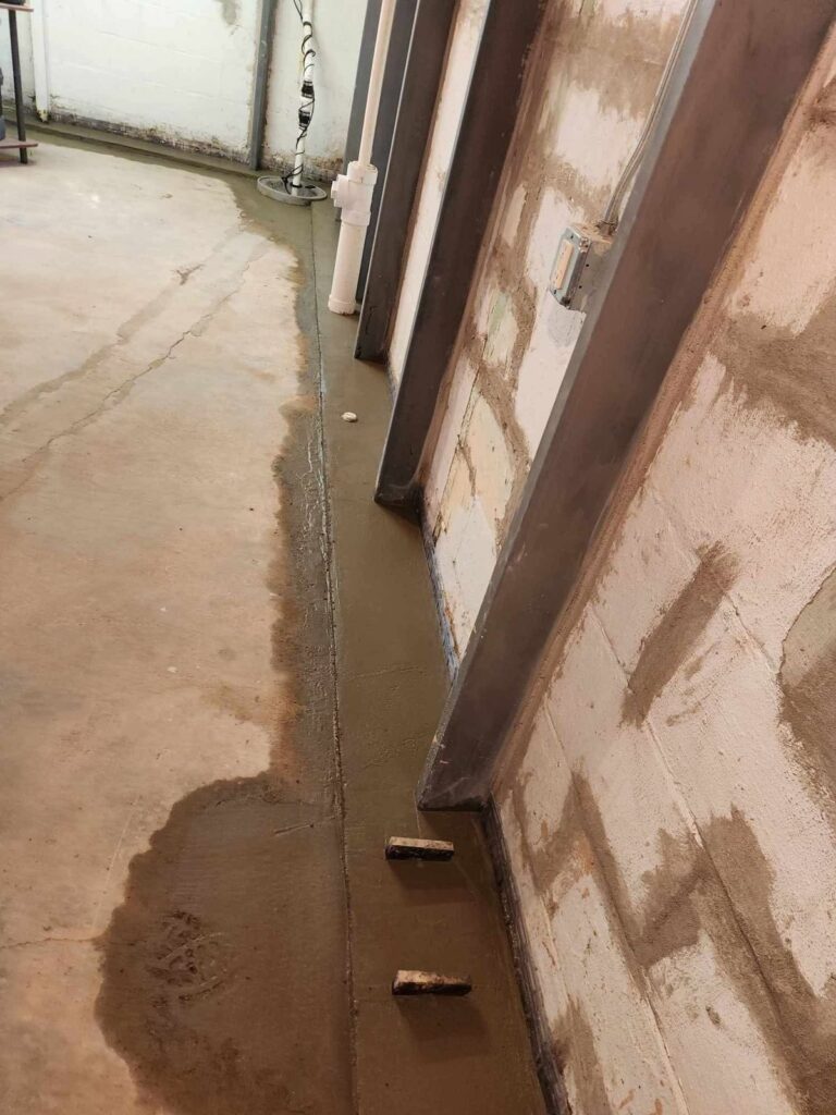 Interior basement waterproofing and foundation repair project in Menasha, WI (photo 7)